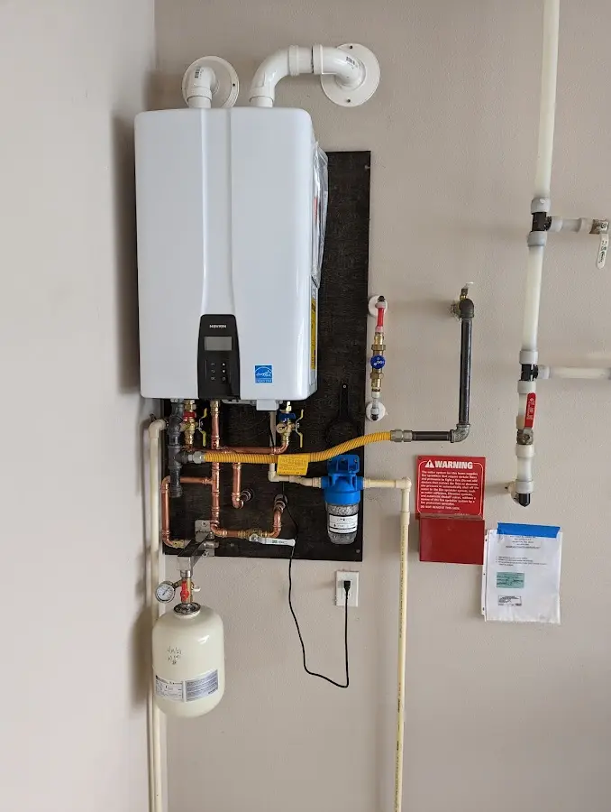 Professional plumber installing copper piping in a Hamlin home